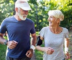 Older man and women jogging